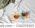 Cozy morning scene with bed, green chlorophyll drink, health vitamin pills. 134259365