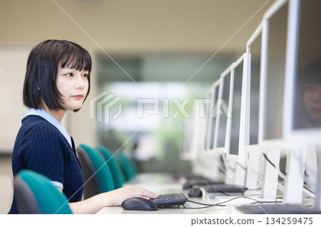 A woman heading to a computer 134259475