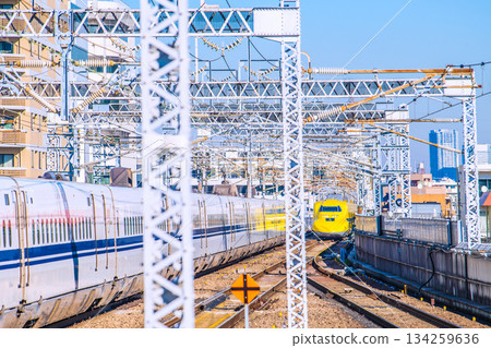 Yokohama cityscape in Japan: countless overhead power lines and rails... Doctor Yellow, the eye that watches over the safety of the Shinkansen. On the left is the N700S 134259636