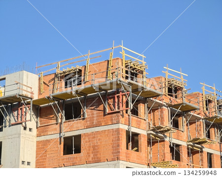 construction progress documented, building progress captured with scaffolding and insulation details construction progress documented, building progress captured with scaffolding and insulation details 134259948