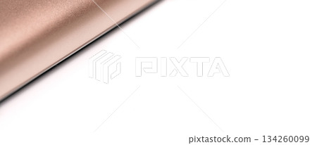 Rose gold colored metal smartphone case, closeup macro detail forming diagonal line with space for text right, abstract technology background Rose gold colored metal smartphone case, closeup macro detail forming diagonal line with space for text right, abstract technology background 134260099