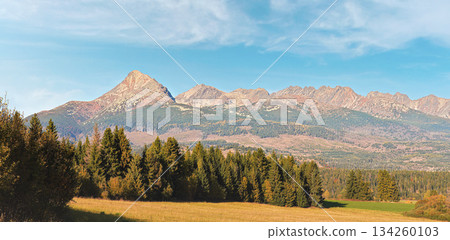 Autumn meadows near country road, panorama of Tatry mountains with Krivak peak (Slovak symbol) as seen from Vazec village in distance Autumn meadows near country road, panorama of Tatry mountains with Krivak peak (Slovak symbol) as seen from Vazec village in distance 134260103