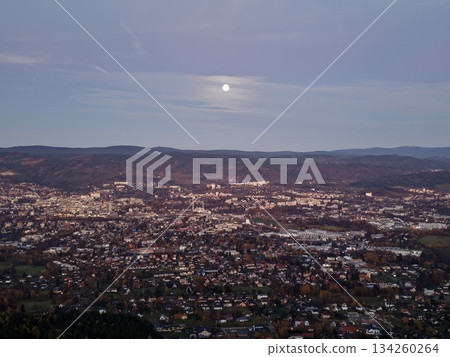 dusk urban panorama, gentle evening illumination casting calm across extensive city under sunset sky dusk urban panorama, gentle evening illumination casting calm across extensive city under sunset sky 134260264