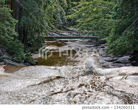 rapid water over rugged stones, moving water crashes over jagged rocks creating lively outdoor scenes rapid water over rugged stones, moving water crashes over jagged rocks creating lively outdoor scenes 134260311