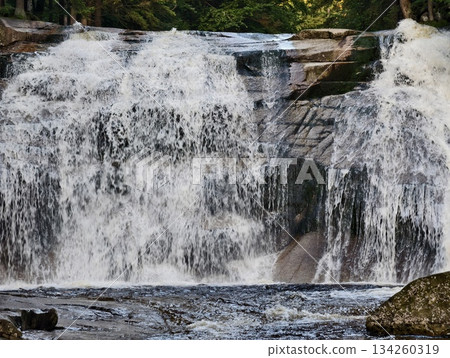 breathtaking waterfall vista, impressive panoramic display of powerful waterfalls amid misty terrain 134260319