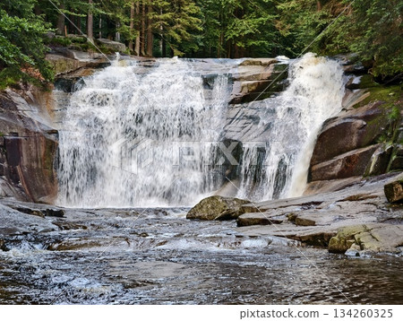 swirling currents in serene river landscape, calm rapids with textured stones and vibrant flowing water swirling currents in serene river landscape, calm rapids with textured stones and vibrant flowing water 134260325