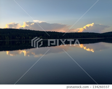 vivid landscape with vibrant sky, cinematic lake view contrasting fiery clouds and tranquil water 134260337