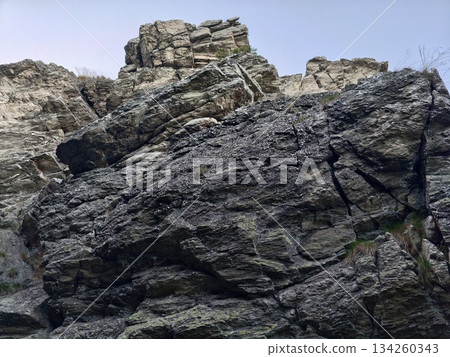 solid stone layers, distinctive jagged stone faces displaying sedimentary layer patterns and geology 134260343