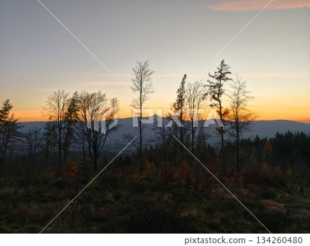 calm dusk in mountain woods, gentle sunset casting shadows over foggy mountain landscape at twilight calm dusk in mountain woods, gentle sunset casting shadows over foggy mountain landscape at twilight 134260480
