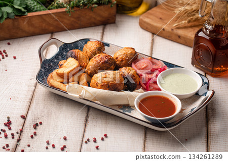 Grilled champignon mushroom skewers with sauce 134261289