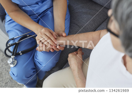Physician or cardiologist holding senior patient by hand to show support and compassion Physician or cardiologist holding senior patient by hand to show support and compassion 134261989