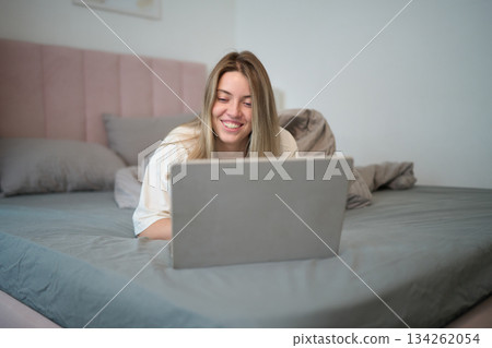Playful Morning Browsing While Resting in Bed 134262054