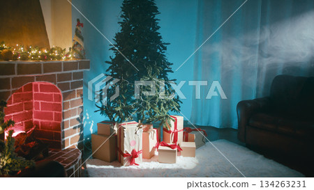 Beam of Light Illuminates Christmas Tree Next to Fireplace Beam of Light Illuminates Christmas Tree Next to Fireplace 134263231