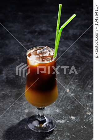 Iced Coffee Layered Drink in Glass with Green Straws Iced Coffee Layered Drink in Glass with Green Straws 134264117