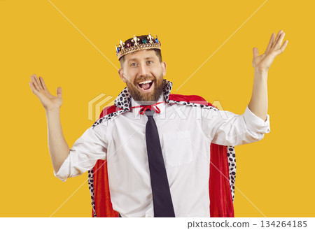 Happy funny business man wearing king cape and crown together with his office clothes 134264185