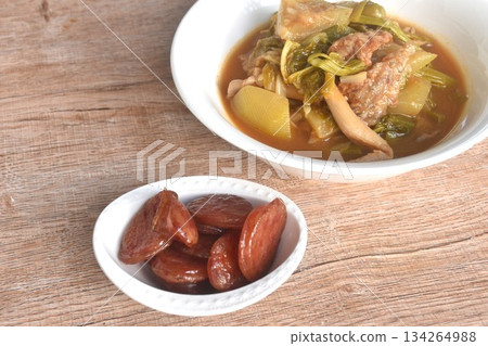 spicy boiled tilapia fish with mixed vegetable in curry soup Thai food in bowl and fried sweet Chinese sausage spicy boiled tilapia fish with mixed vegetable in curry soup Thai food in bowl and fried sweet Chinese sausage 134264988