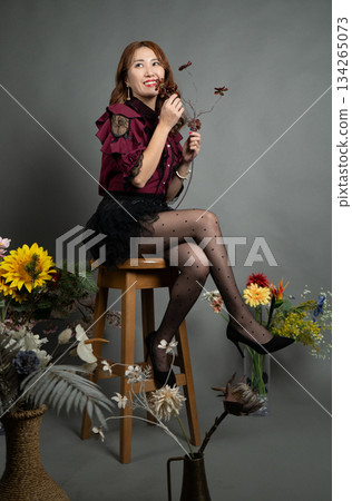 A young woman sitting on a chair A young woman sitting on a chair 134265073