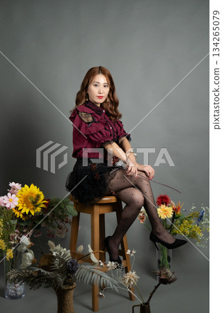 A young woman sitting on a chair A young woman sitting on a chair 134265079