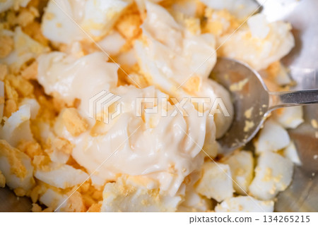 Mixing mashed boiled eggs and mayonnaise 134265215