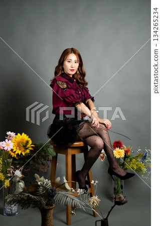 A young woman sitting on a chair A young woman sitting on a chair 134265234
