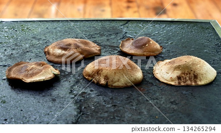 Shiitake mushrooms being cooked on a hot plate Shiitake mushrooms being cooked on a hot plate 134265294