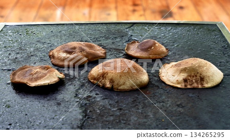 Shiitake mushrooms being cooked on a hot plate 134265295