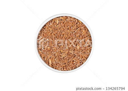 A bowl of brown grains with a white background A bowl of brown grains with a white background 134265794