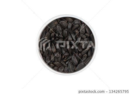 A bowl of black seeds on a white background 134265795