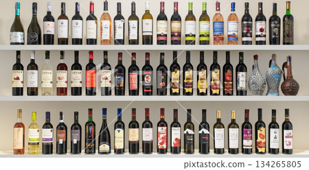 Yerevan Armenia 12.5.2025. A shelf full of wine bottles with a variety of colors and labels 134265805