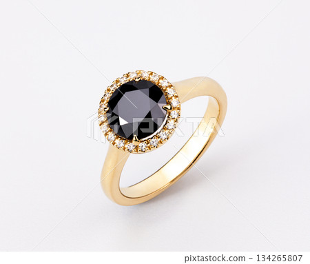 A gold and black diamond ring with a halo of diamonds 134265807