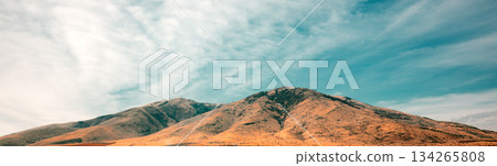 A mountain range with a clear blue sky in the background 134265808