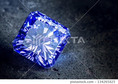A blue diamond is sitting on a grey surface A blue diamond is sitting on a grey surface 134265825