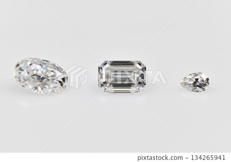 Three different shaped white diamonds are displayed on a white background Three different shaped white diamonds are displayed on a white background 134265941