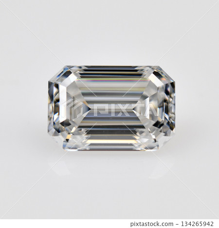A white emerald cut diamond is sitting on a white background 134265942