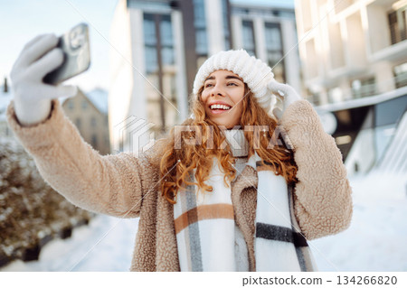 Beautiful female tourist with phone having fun outdoors. Travel concept. Beautiful female tourist with phone having fun outdoors. Travel concept. 134266820