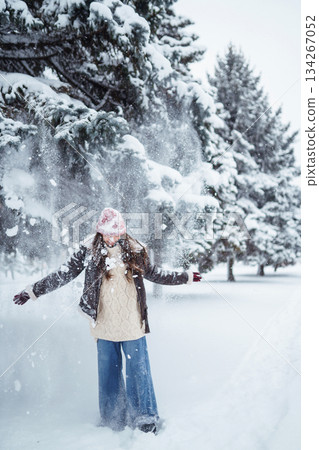 Beautiful Woman Wearing Fashionable Winter Clothes walking in winter nature. Holidays concept. Beautiful Woman Wearing Fashionable Winter Clothes walking in winter nature. Holidays concept. 134267052