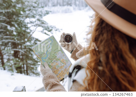 Woman is wearing a winter jacket, hat, scarf and backpack. Enjoying winter travel. Active lifestyle. Woman is wearing a winter jacket, hat, scarf and backpack. Enjoying winter travel. Active lifestyle. 134267463