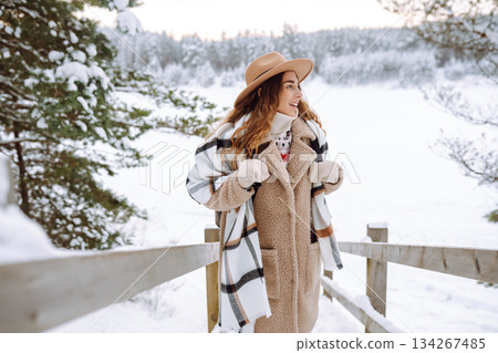 Woman traveler in a hat with a backpack on a wooden ladder. Active lifestyle. Travel concept. 134267485