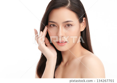 A beautiful young Asian woman with clean, fresh skin against a white background. Skincare, facial treatment, cosmetology, beauty, and spa. An elegant portrait of an Asian woman. 134267701