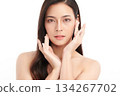 A beautiful young Asian woman with clean, fresh skin against a white background. Skincare, facial treatment, cosmetology, beauty, and spa. An elegant portrait of an Asian woman. 134267702