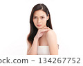 A beautiful young Asian woman with clean, fresh skin against a white background. Skincare, facial treatment, cosmetology, beauty, and spa. An elegant portrait of an Asian woman. 134267752