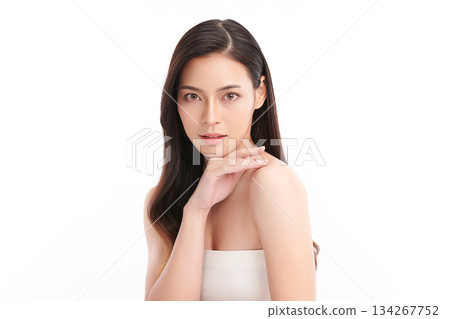 A beautiful young Asian woman with clean, fresh skin against a white background. Skincare, facial treatment, cosmetology, beauty, and spa. An elegant portrait of an Asian woman. 134267752