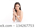 A beautiful young Asian woman with clean, fresh skin against a white background. Skincare, facial treatment, cosmetology, beauty, and spa. An elegant portrait of an Asian woman. 134267753