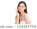 A beautiful young Asian woman with clean, fresh skin against a white background. Skincare, facial treatment, cosmetology, beauty, and spa. An elegant portrait of an Asian woman. 134267754