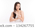 A beautiful young Asian woman with clean, fresh skin against a white background. Skincare, facial treatment, cosmetology, beauty, and spa. An elegant portrait of an Asian woman. 134267755