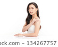 A beautiful young Asian woman with clean, fresh skin against a white background. Skincare, facial treatment, cosmetology, beauty, and spa. An elegant portrait of an Asian woman. 134267757
