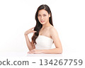 A beautiful young Asian woman with clean, fresh skin against a white background. Skincare, facial treatment, cosmetology, beauty, and spa. An elegant portrait of an Asian woman. 134267759
