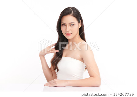 A beautiful young Asian woman with clean, fresh skin against a white background. Skincare, facial treatment, cosmetology, beauty, and spa. An elegant portrait of an Asian woman. 134267759