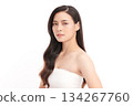 A beautiful young Asian woman with clean, fresh skin against a white background. Skincare, facial treatment, cosmetology, beauty, and spa. An elegant portrait of an Asian woman. 134267760