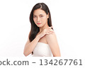 A beautiful young Asian woman with clean, fresh skin against a white background. Skincare, facial treatment, cosmetology, beauty, and spa. An elegant portrait of an Asian woman. 134267761